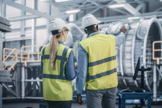 two,diverse,professional,heavy,industry,engineers,wearing,safety,uniform,and